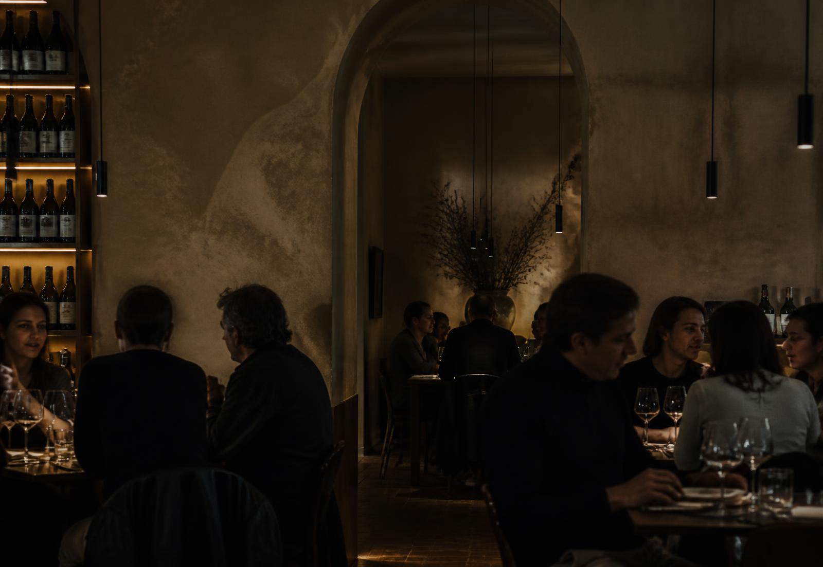 Guests dining in BRASA's softly lit room